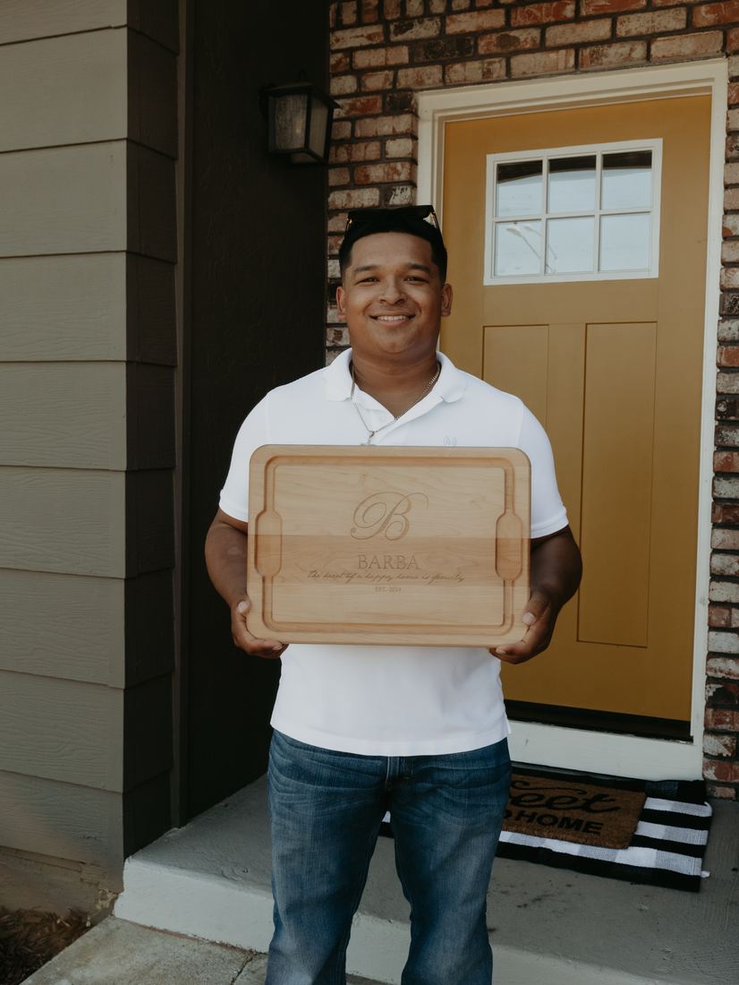 New homeowner holding a keepsake box at the front door