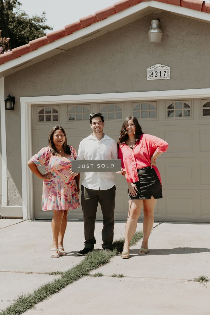Couple celebrating in front of their new garage on closing day