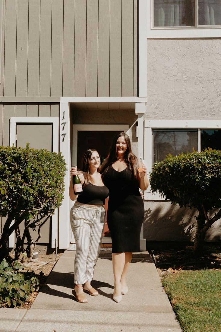 Couple in front of their new home