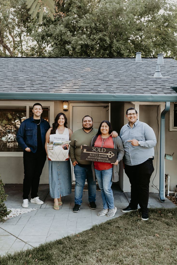 Family on the front porch of their new home