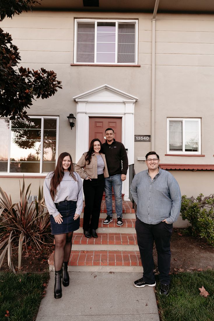 Family on the front steps of their new home