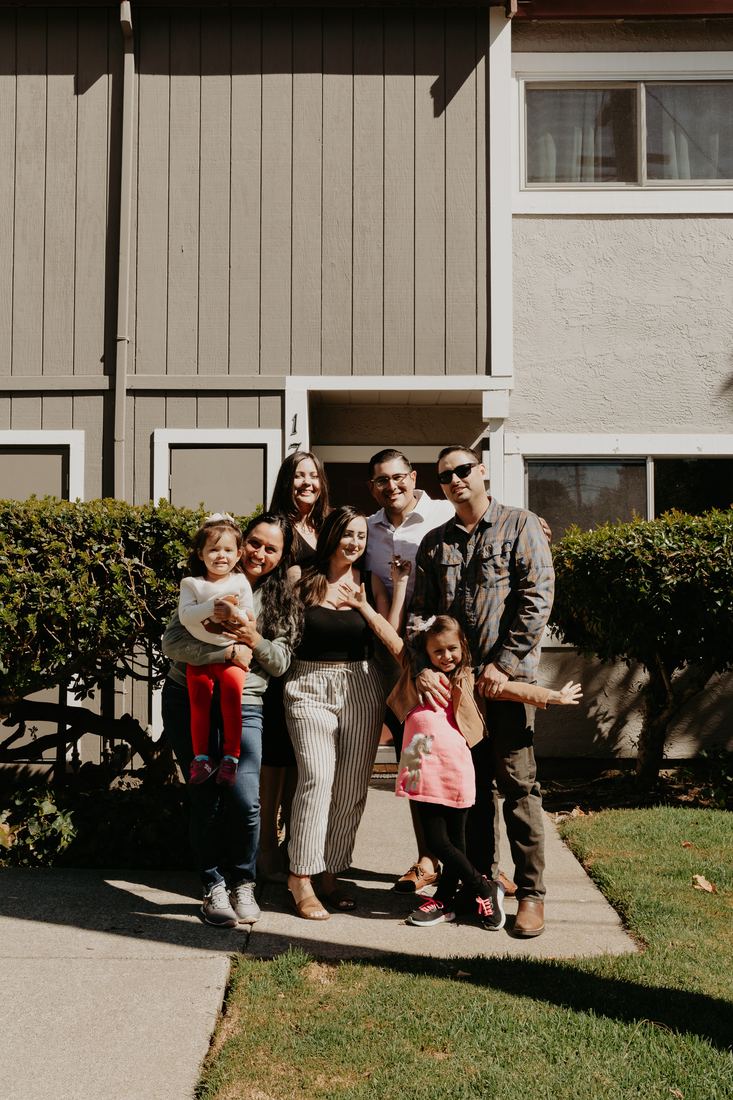 Family in front of their new home