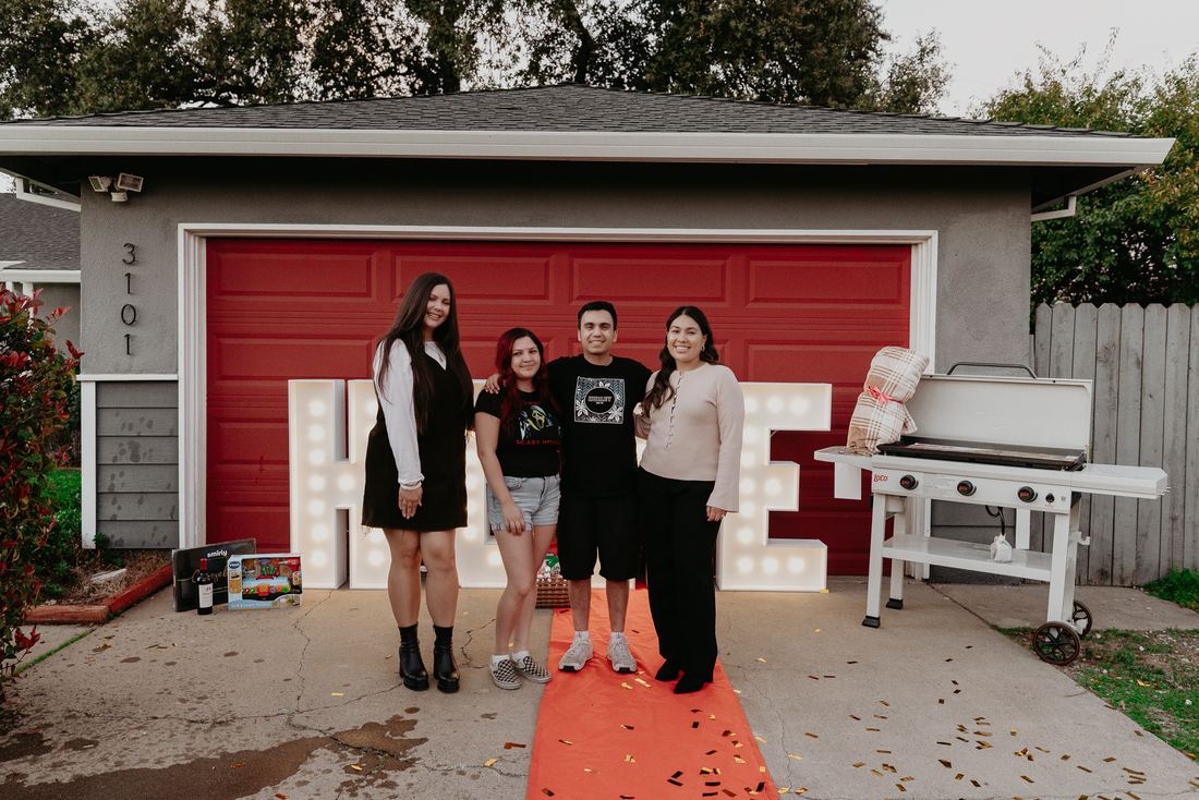 Couple with HOME letters on closing day