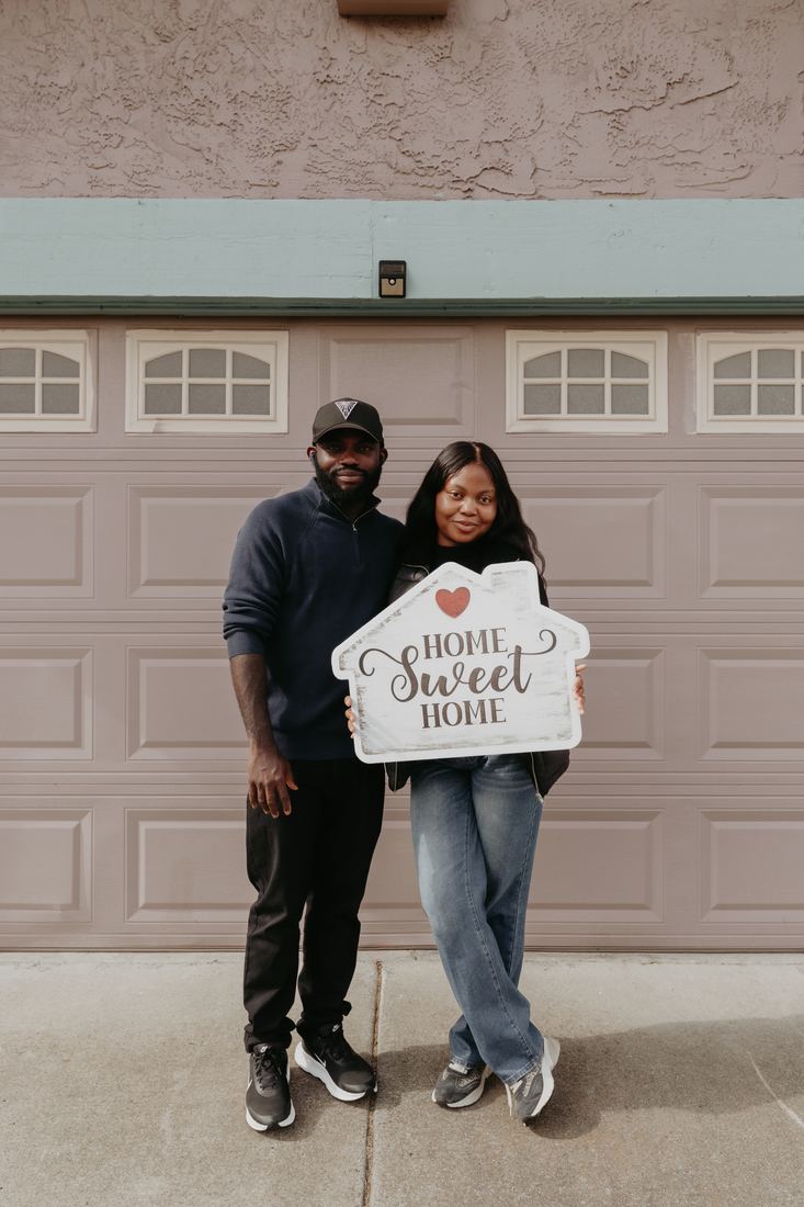 Couple with a Home Sweet Home sign