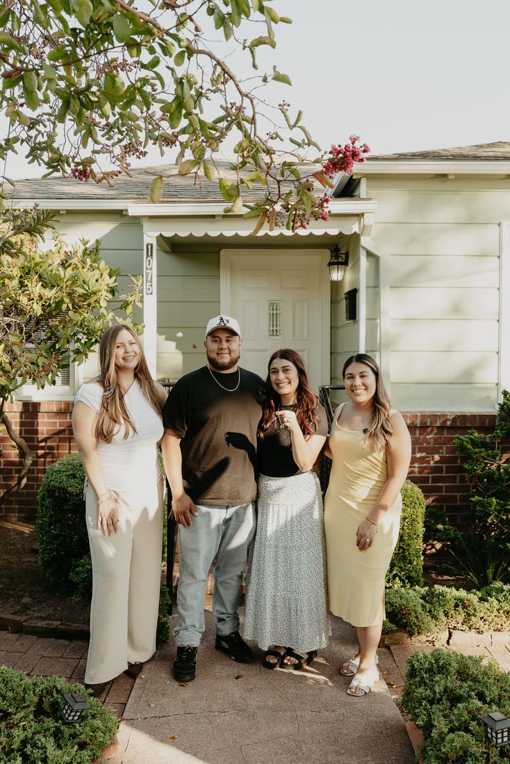 Family in front of their new home on closing day