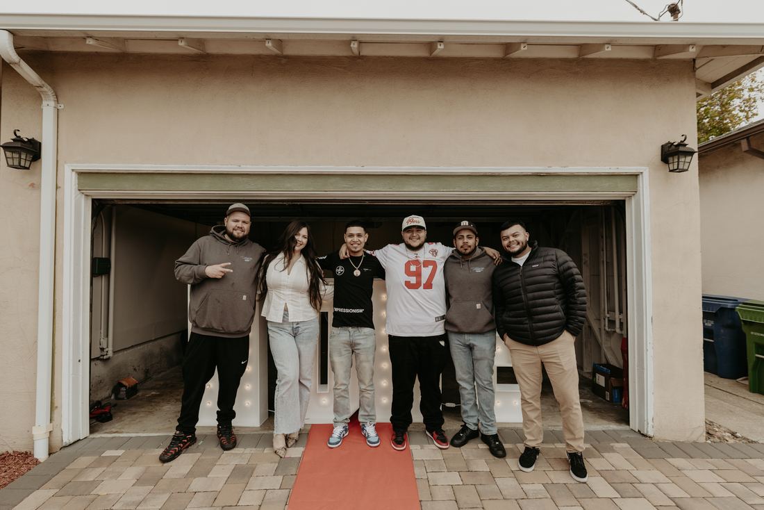 Family on the red carpet outside their new home
