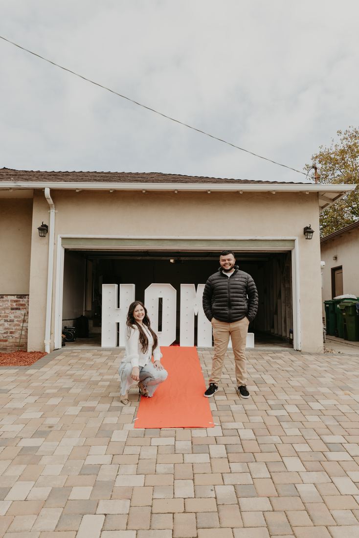 Child with HOME letters in the driveway