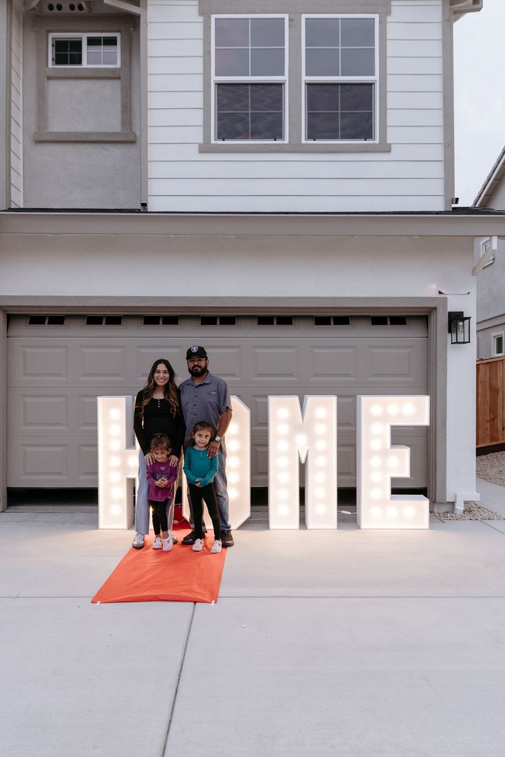 HOME letters lit up outside a new home